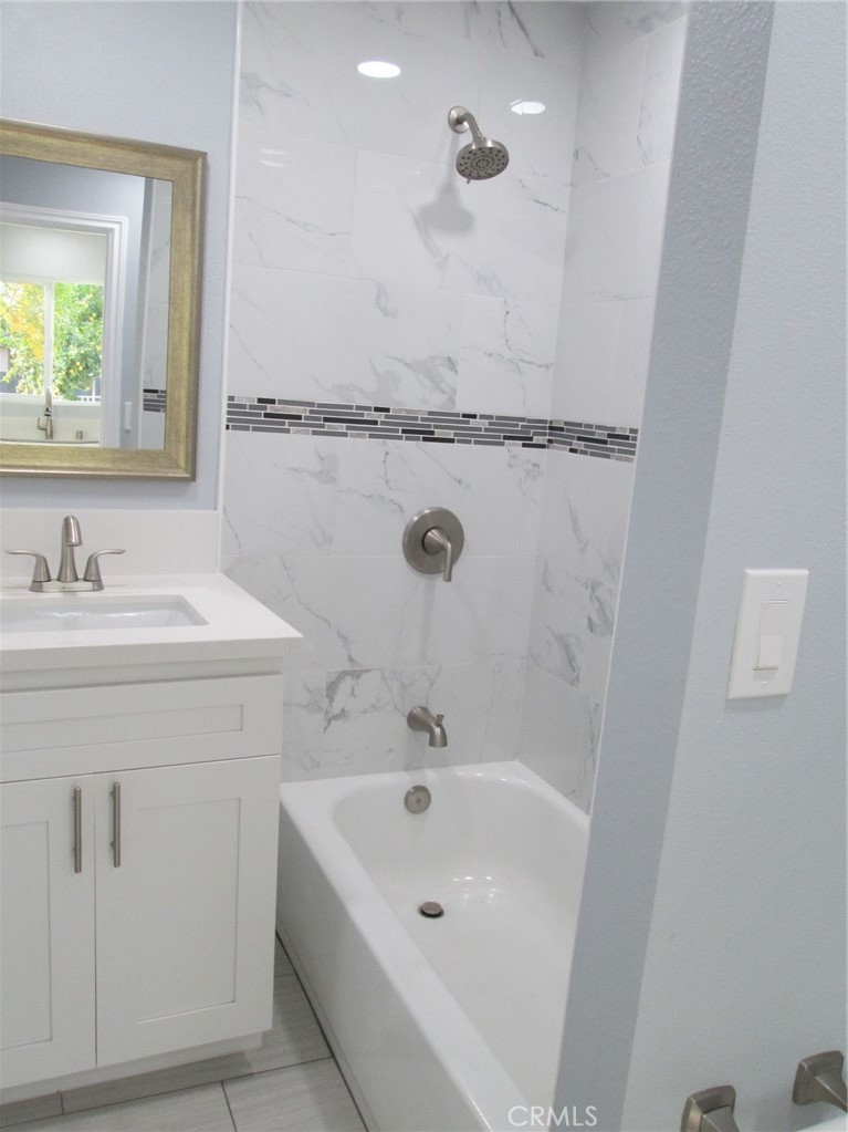 44552 Arabia Street Indio, CA 92201 - Photo 46 of 49 a bathroom with a sink a mirror and a bathtub
