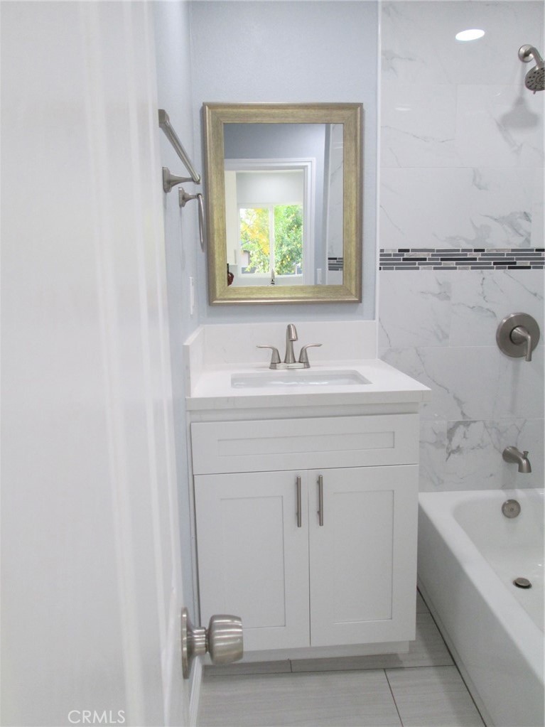 44552 Arabia Street Indio, CA 92201 - Photo 48 of 49 a bathroom with a sink vanity tub and a mirror