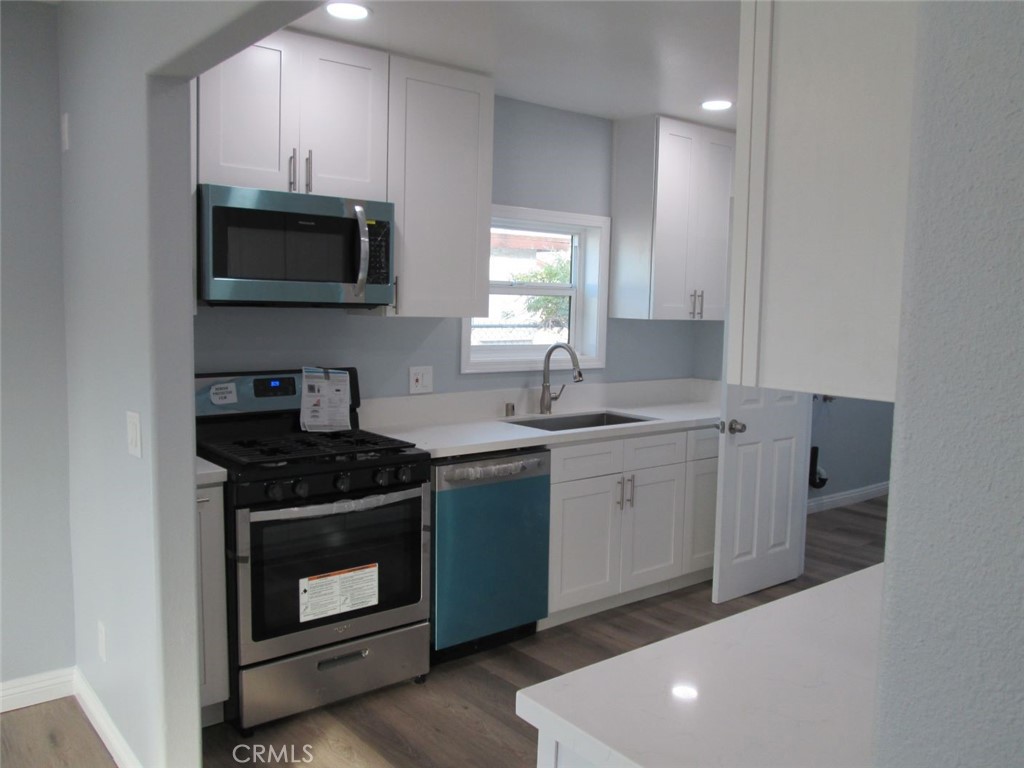 44552 Arabia Street Indio, CA 92201 - Photo 6 of 49 a kitchen with sink a microwave and cabinets