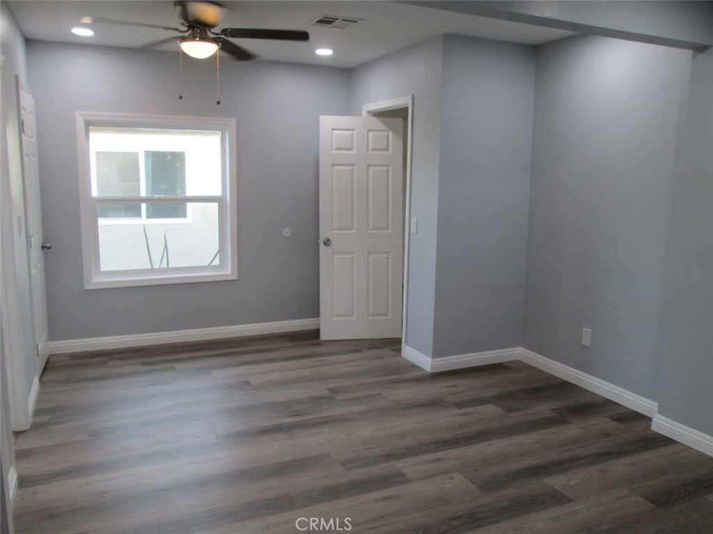 44552 Arabia Street Indio, CA 92201 - Photo 9 of 49 an empty room with wooden floor and windows