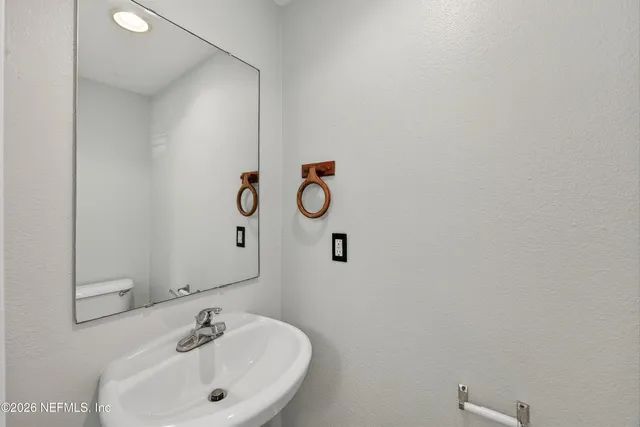 a bathroom with a sink and mirror