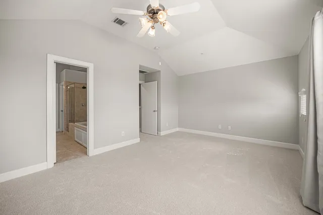 a view of an empty room with a ceiling fan