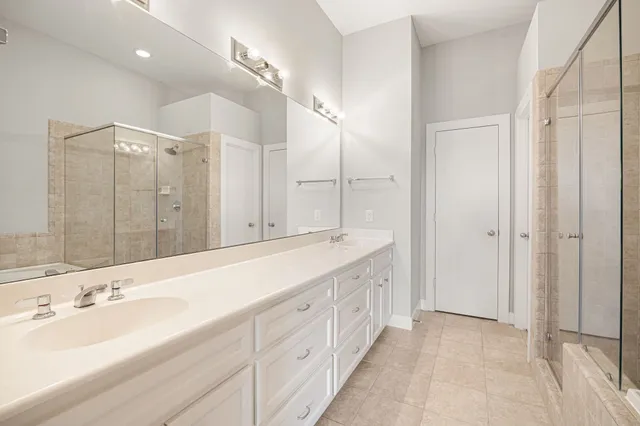 a spacious bathroom with a double vanity sink mirror and double