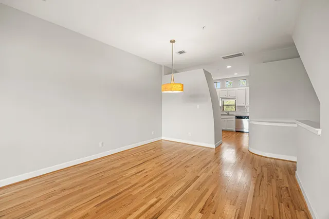 a view of a room with wooden floor and staircase