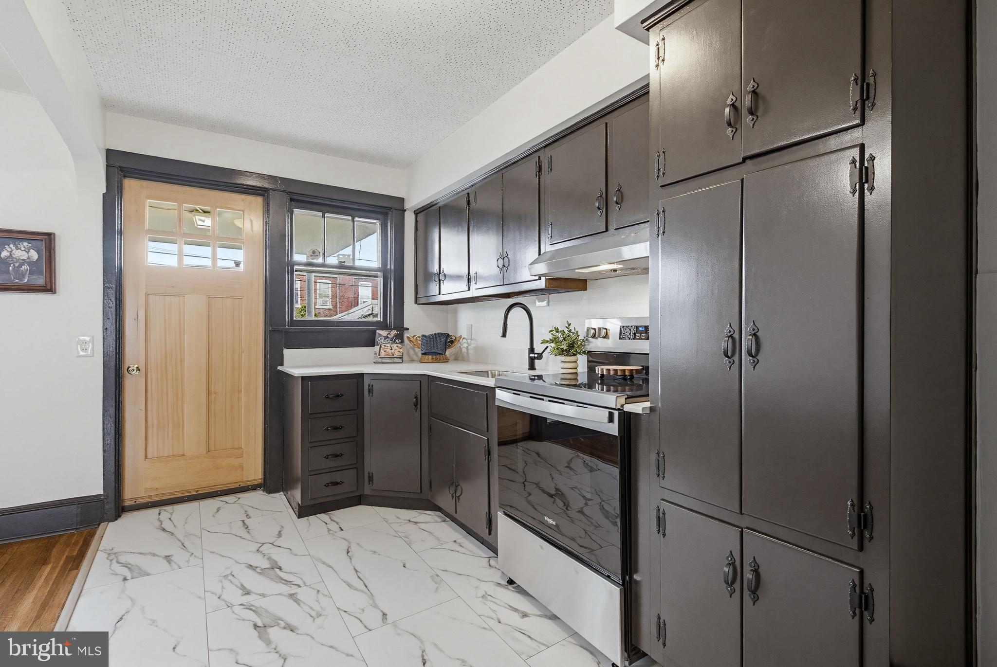 636 3rd Street Lancaster, PA 17603 - Photo 14 of 42 a kitchen with kitchen island white cabinets and refrigerator