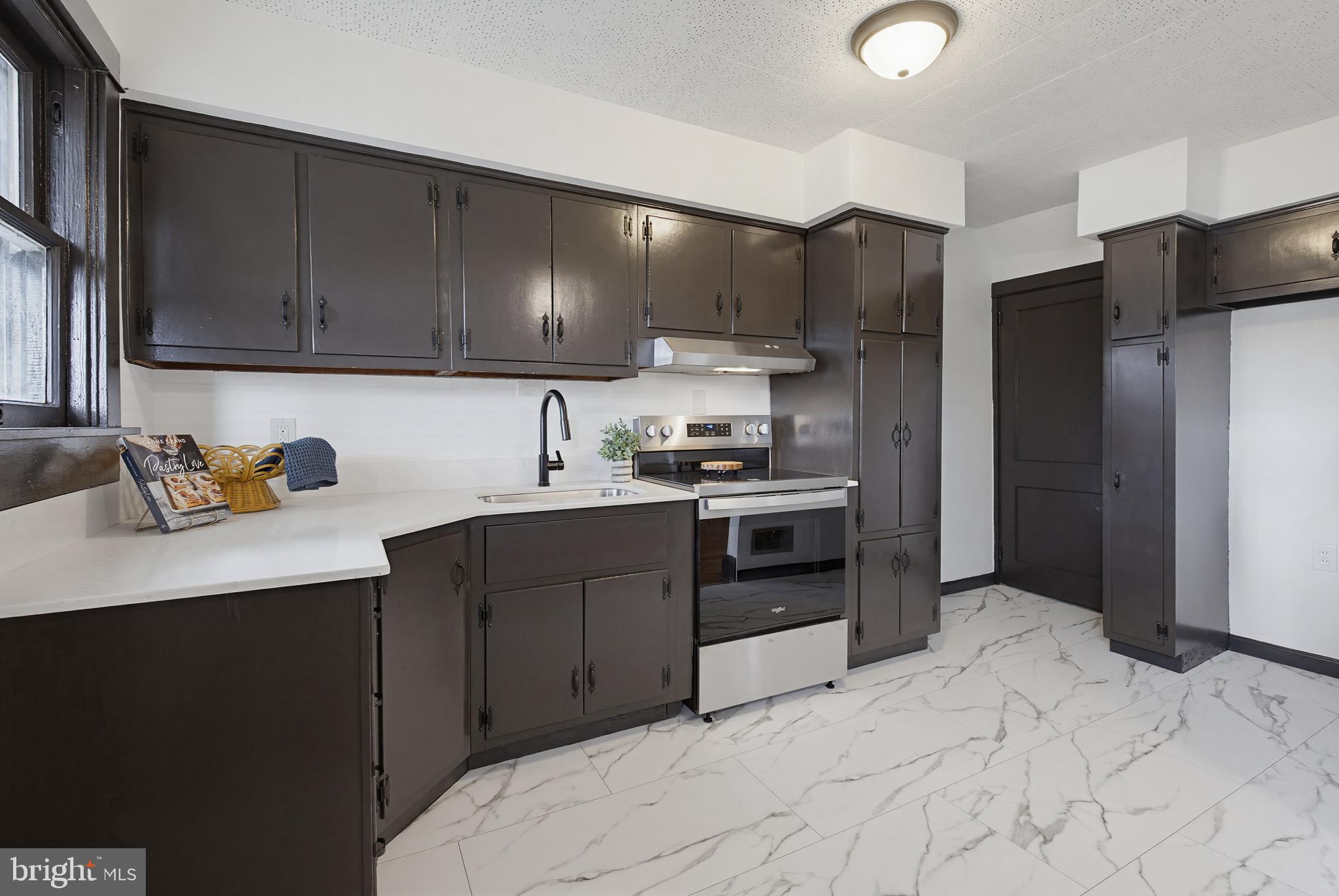 636 3rd Street Lancaster, PA 17603 - Photo 15 of 42 a kitchen with stainless steel appliances kitchen island granite countertop a refrigerator sink and cabinets