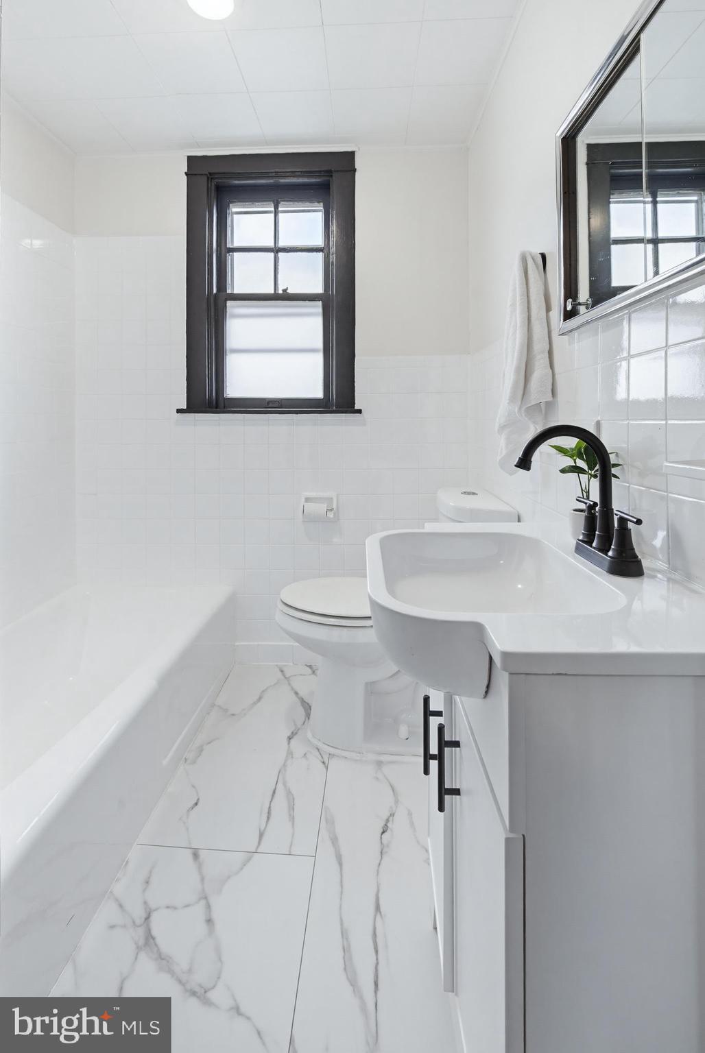 636 3rd Street Lancaster, PA 17603 - Photo 19 of 42 a bathroom with a sink toilet and mirror