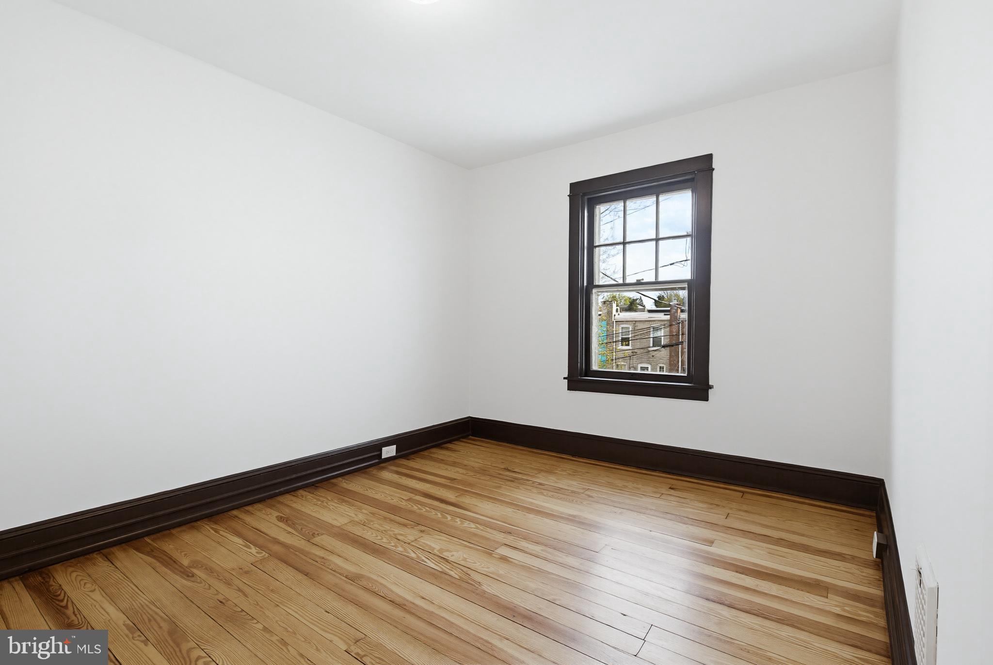 636 3rd Street Lancaster, PA 17603 - Photo 24 of 42 a view of an empty room with wooden floor and a window