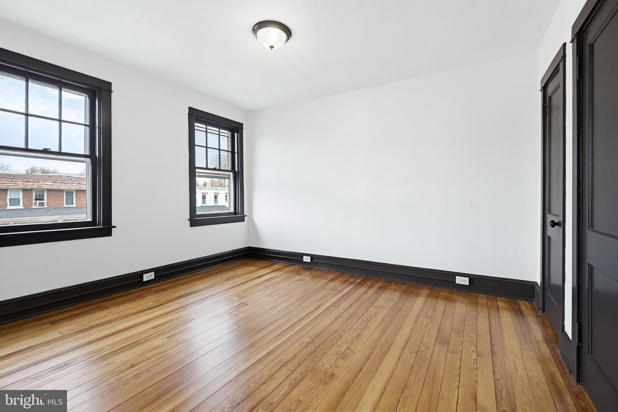 636 3rd Street Lancaster, PA 17603 - Photo 26 of 42 an empty room with wooden floor and windows