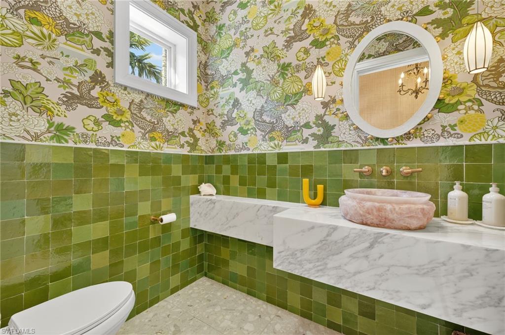 111 Caribbean Road Naples, FL 34108 - Photo 39 of 50 a view of bathroom with toilet mirror and sink