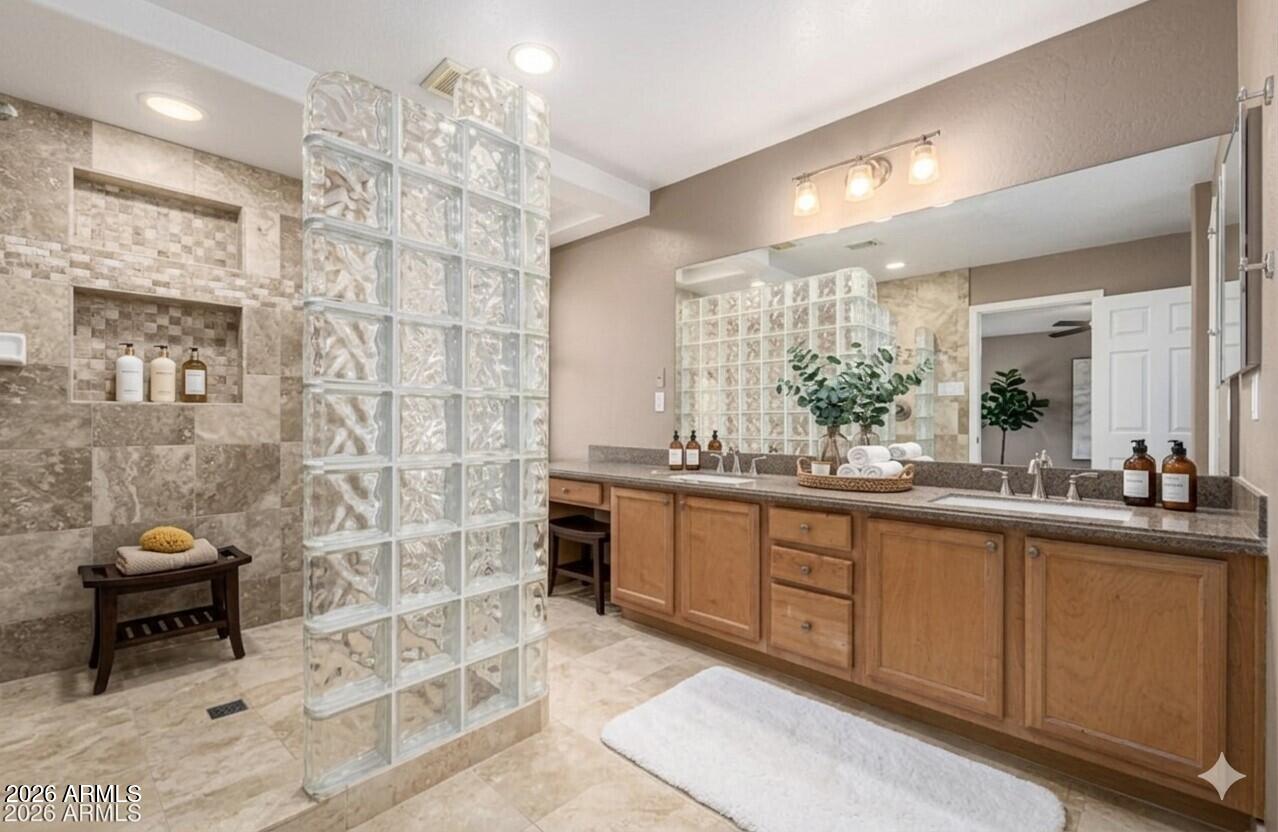 6356 West Avenida Del Rey Phoenix, AZ 85083 - Photo 15 of 31 a bathroom with a double vanity sink a toilet a mirror and shower