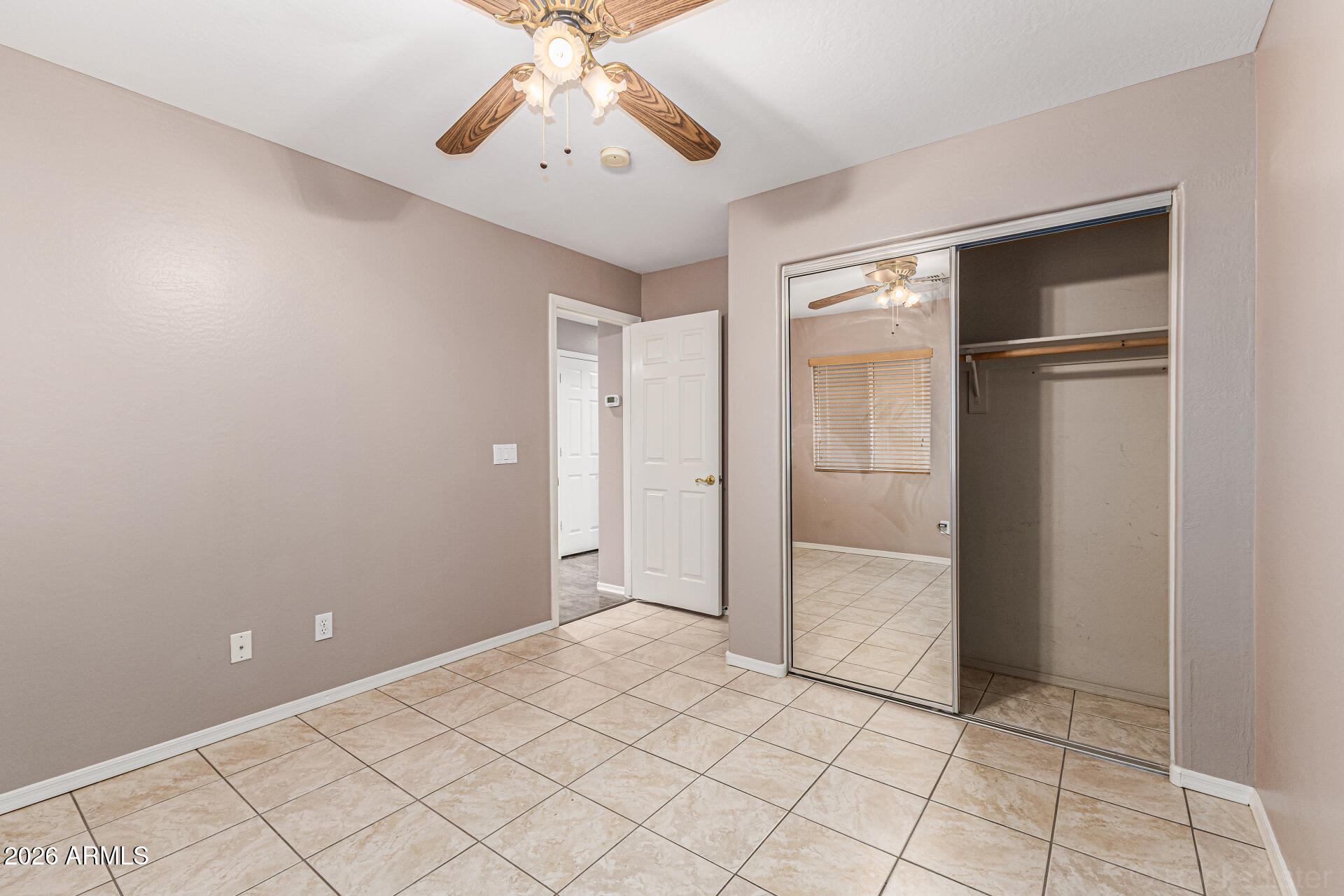 6356 West Avenida Del Rey Phoenix, AZ 85083 - Photo 18 of 31 an empty room with chandelier fan