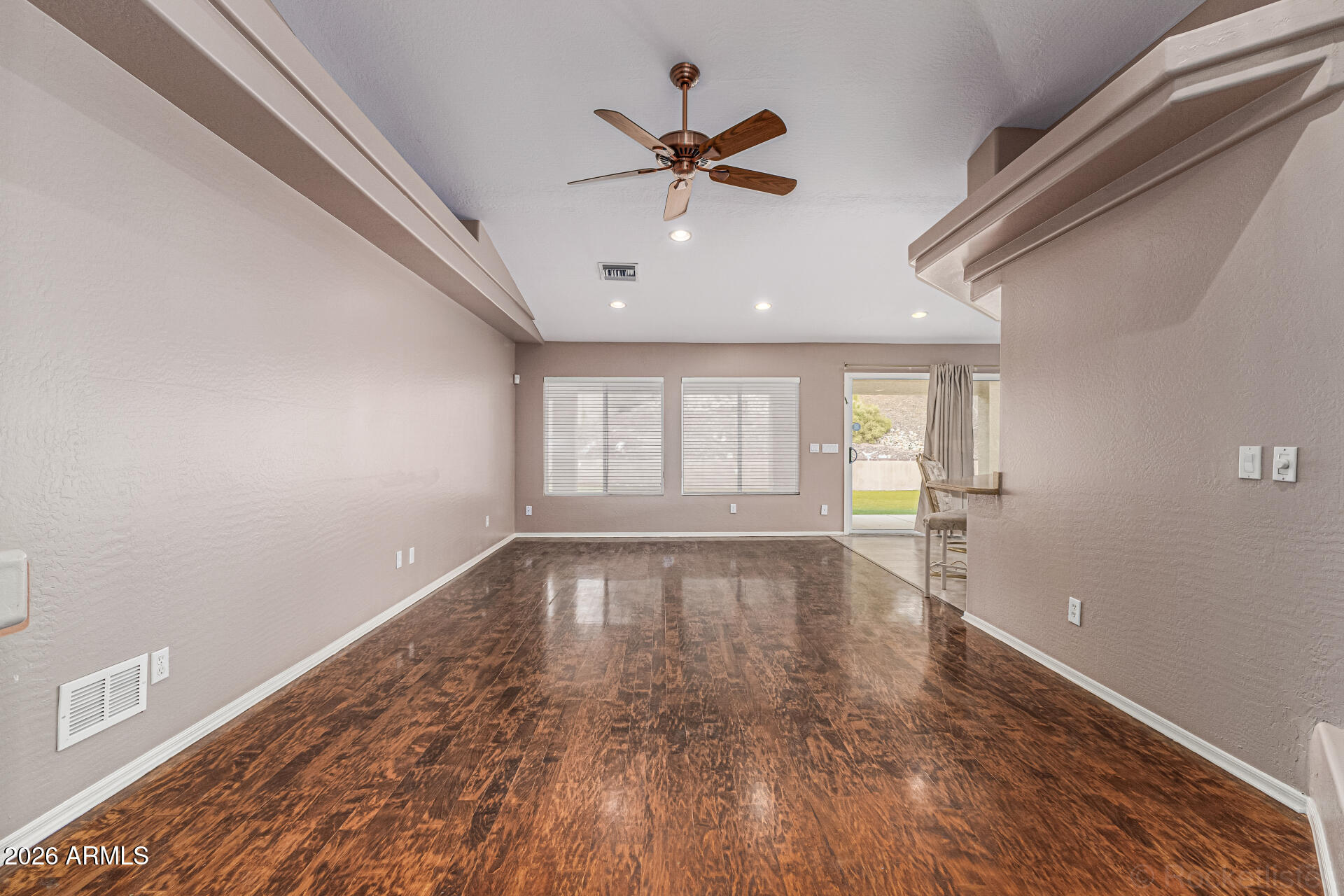 6356 West Avenida Del Rey Phoenix, AZ 85083 - Photo 4 of 31 a view of an empty room with wooden floor and a window