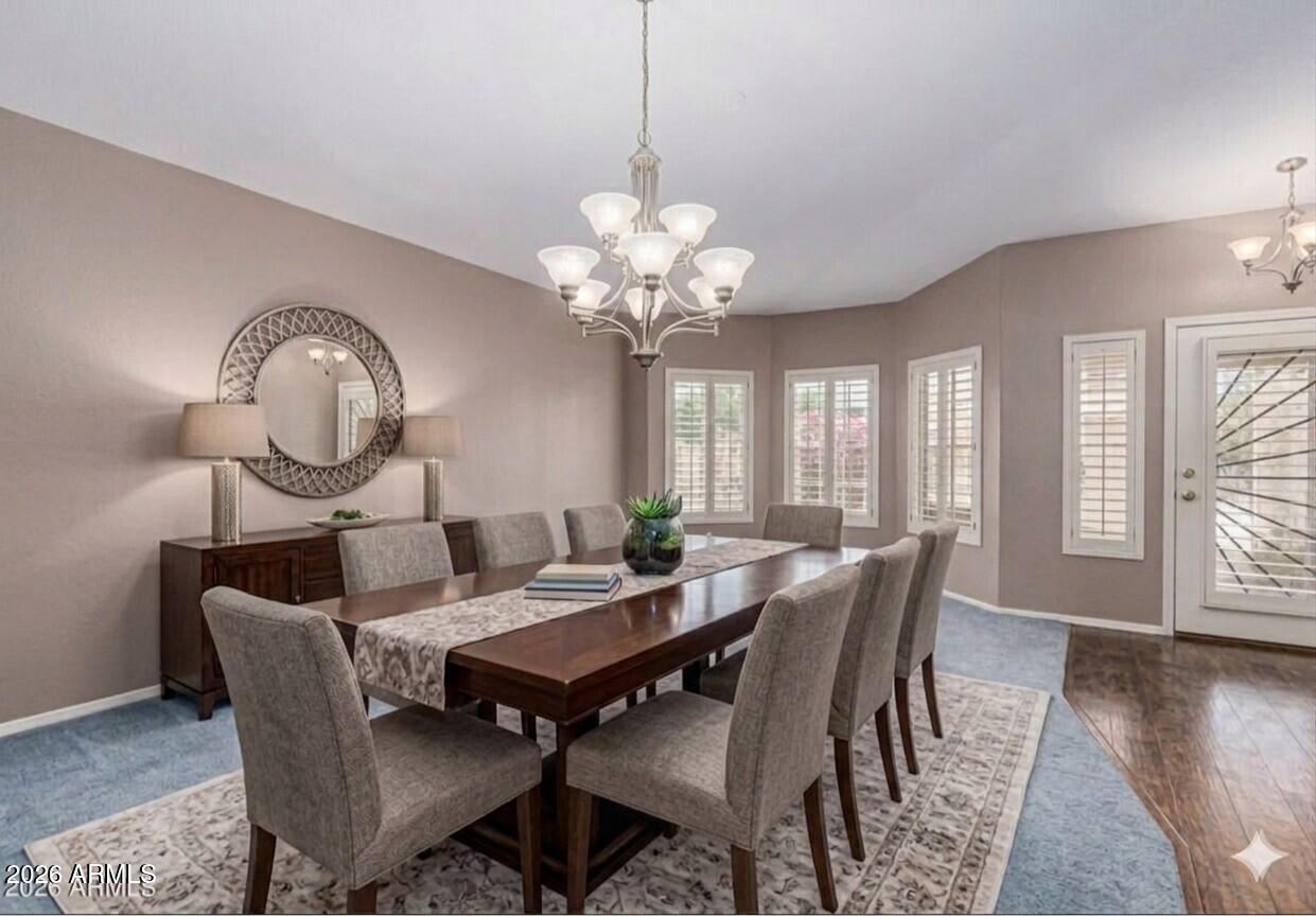6356 West Avenida Del Rey Phoenix, AZ 85083 - Photo 7 of 31 a dining room with furniture a chandelier and wooden floor