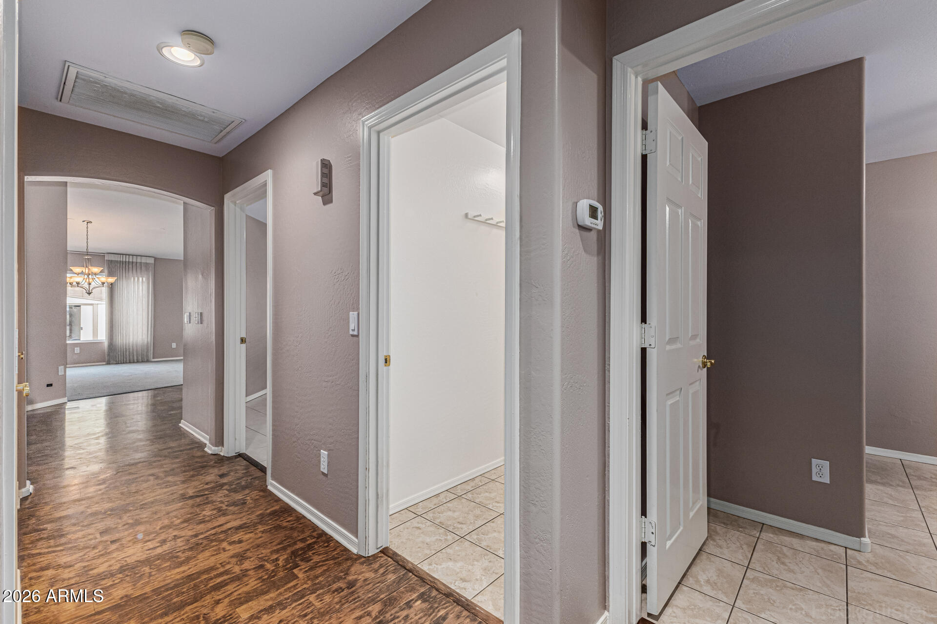 6356 West Avenida Del Rey Phoenix, AZ 85083 - Photo 9 of 31 a view of a hallway with wooden floor and closet