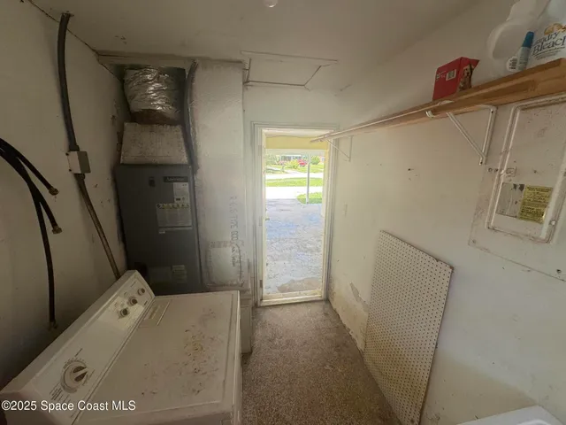 a kitchen with a sink window and cabinets