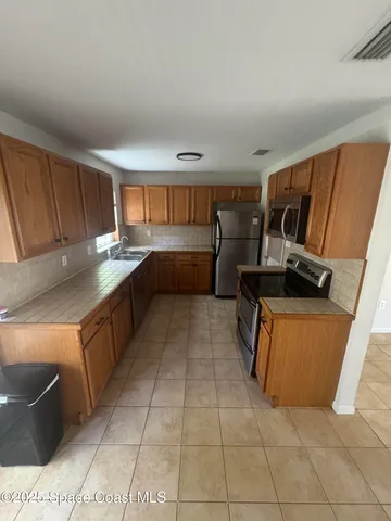 a kitchen with stainless steel appliances granite countertop a sink and cabinets