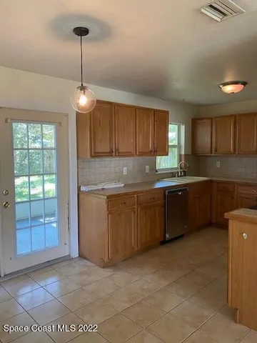 a kitchen with granite countertop a sink cabinets and window