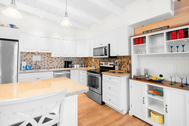 a kitchen with stainless steel appliances granite countertop a sink and cabinets