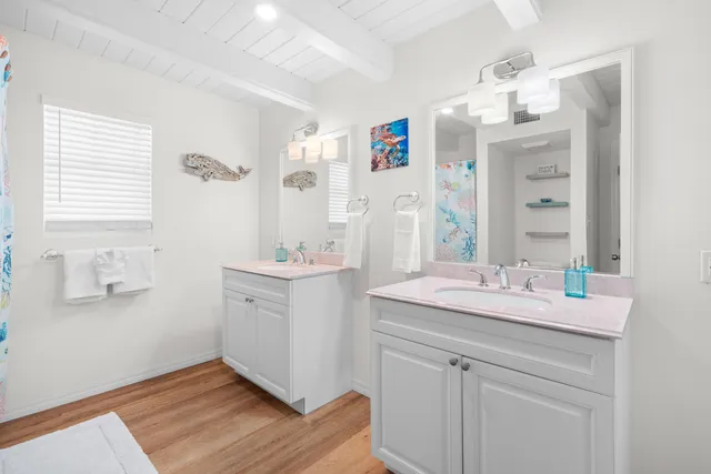 a bathroom with a sink vanity and mirror