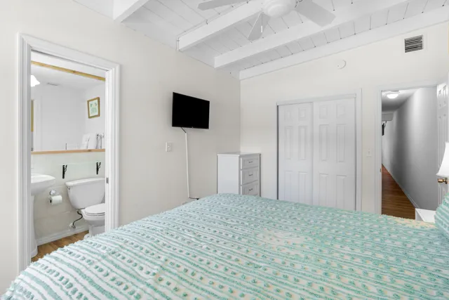 a bedroom with a bed and a flat screen tv