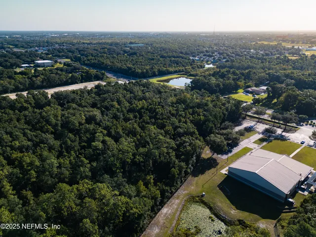 an aerial view of residential houses with outdoor space and swimming pool