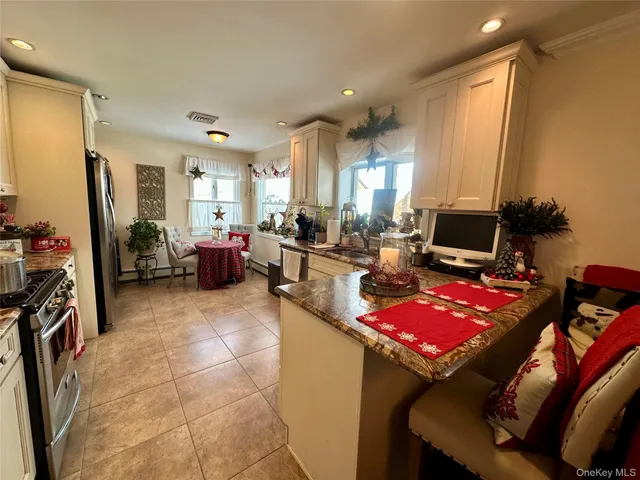 a living room with furniture a flat screen tv and a refrigerator