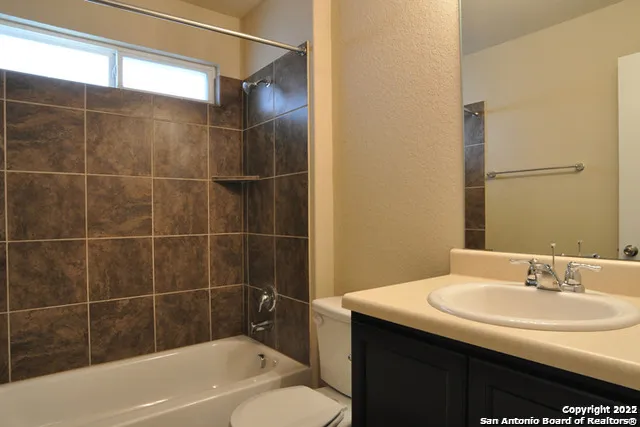 a bathroom with a sink mirror toilet and bathtub