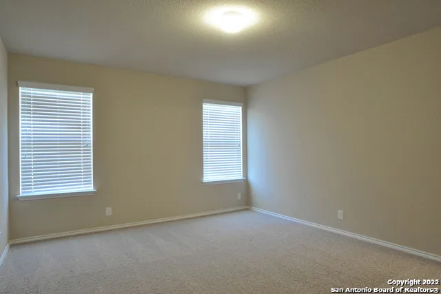 a bathroom with a glass door shower and a sink