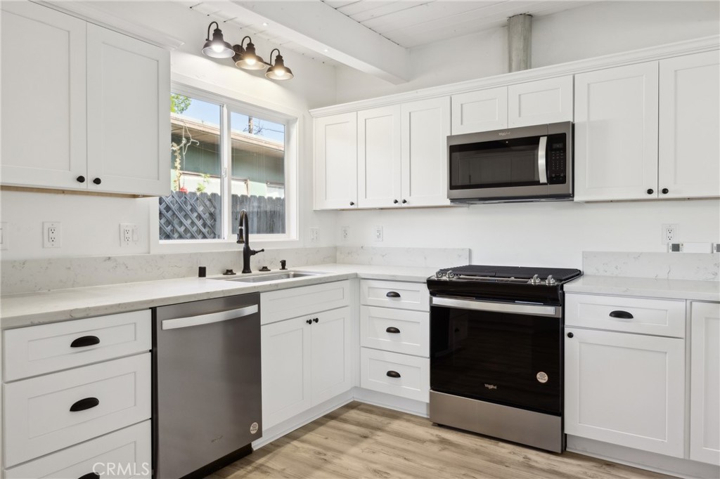 528 Creston Road Paso Robles, CA 93446 - Photo 7 of 46 a kitchen with cabinets stainless steel appliances and a sink