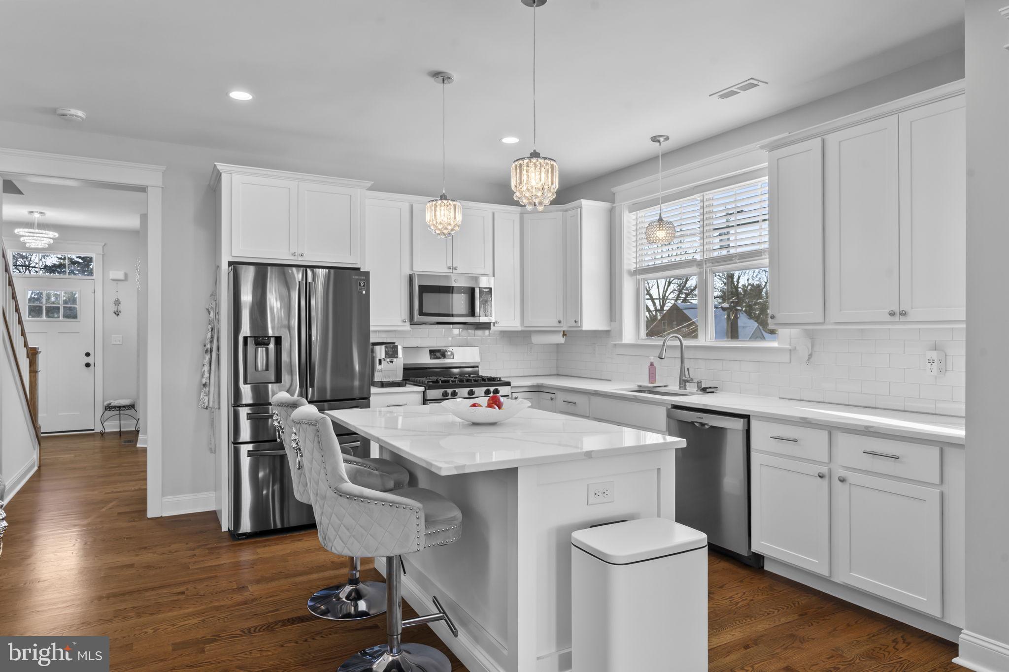 122 Church Road Jenkintown, PA 19046 - Photo 14 of 38 a kitchen with a sink a stove a refrigerator and white cabinets