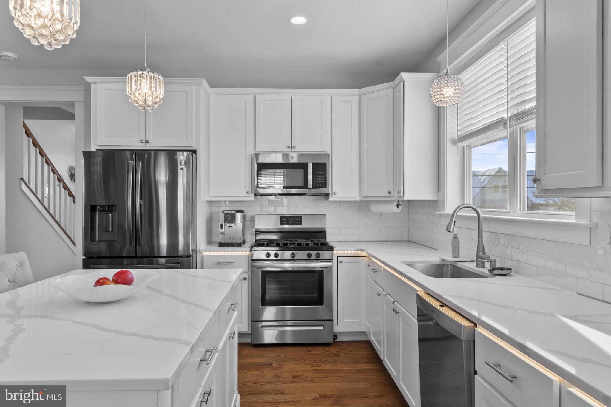 122 Church Road Jenkintown, PA 19046 - Photo 15 of 38 a kitchen with stainless steel appliances granite countertop a sink dishwasher stove and refrigerator
