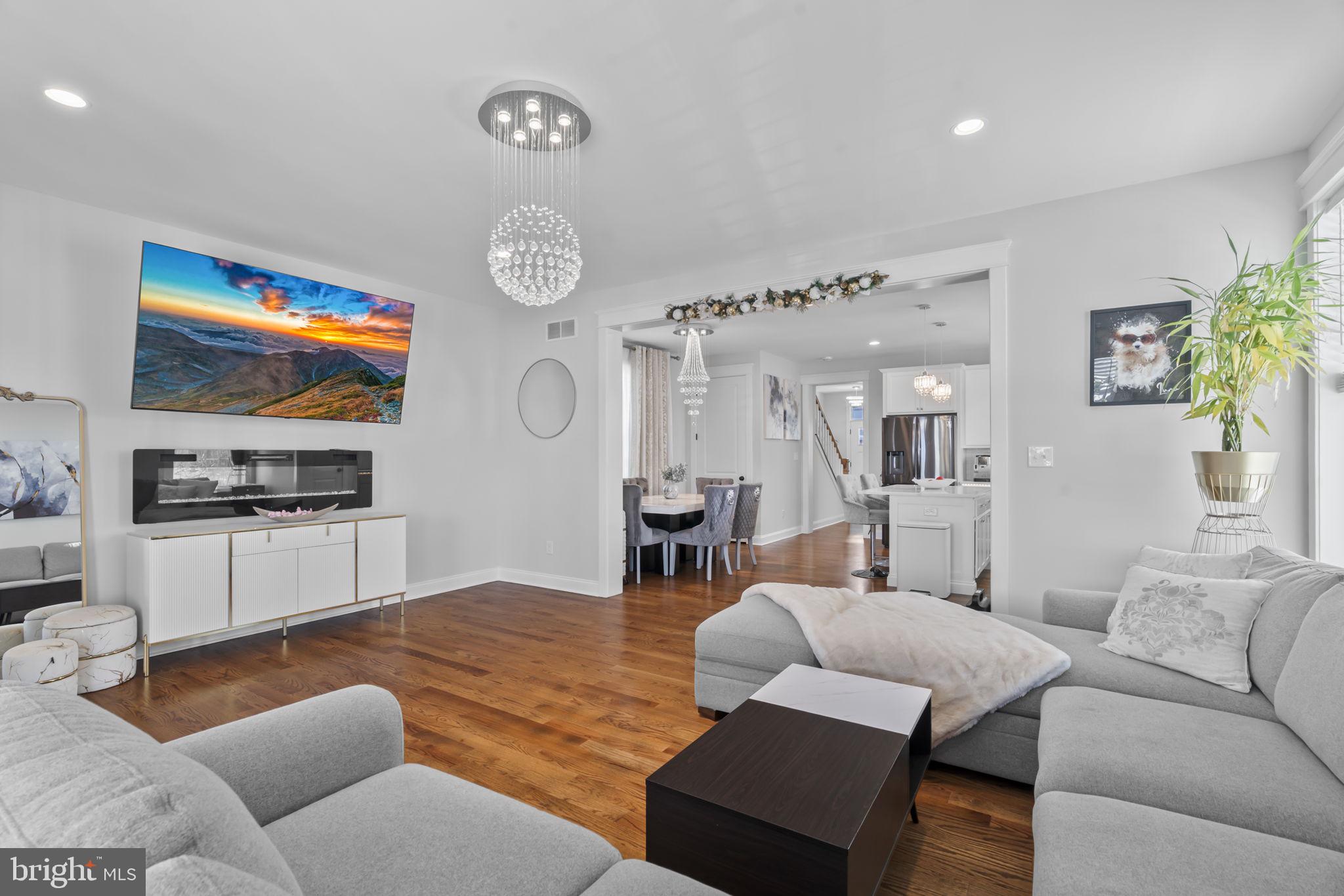 122 Church Road Jenkintown, PA 19046 - Photo 18 of 38 a living room with furniture kitchen view and a chandelier