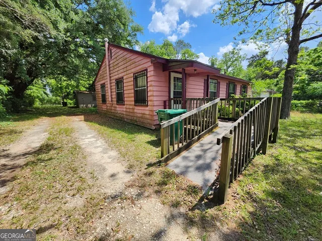 a view of a house with wooden fence