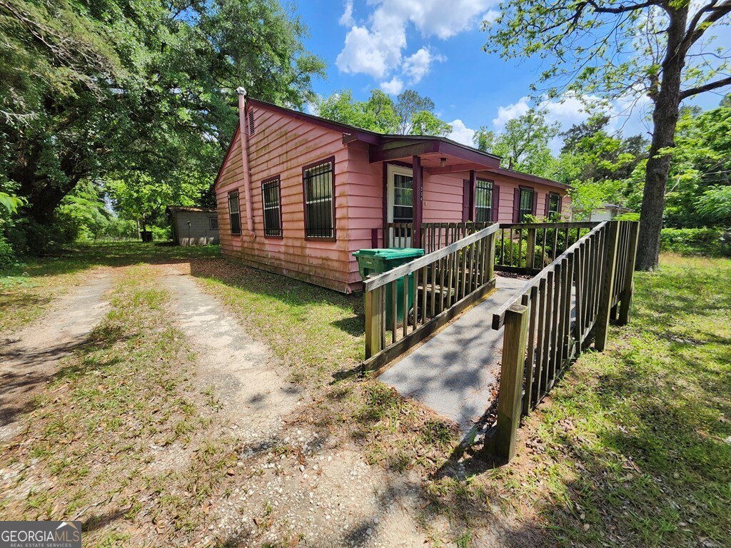 a view of a house with wooden fence
