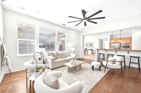 a bed room with a bed and a ceiling fan