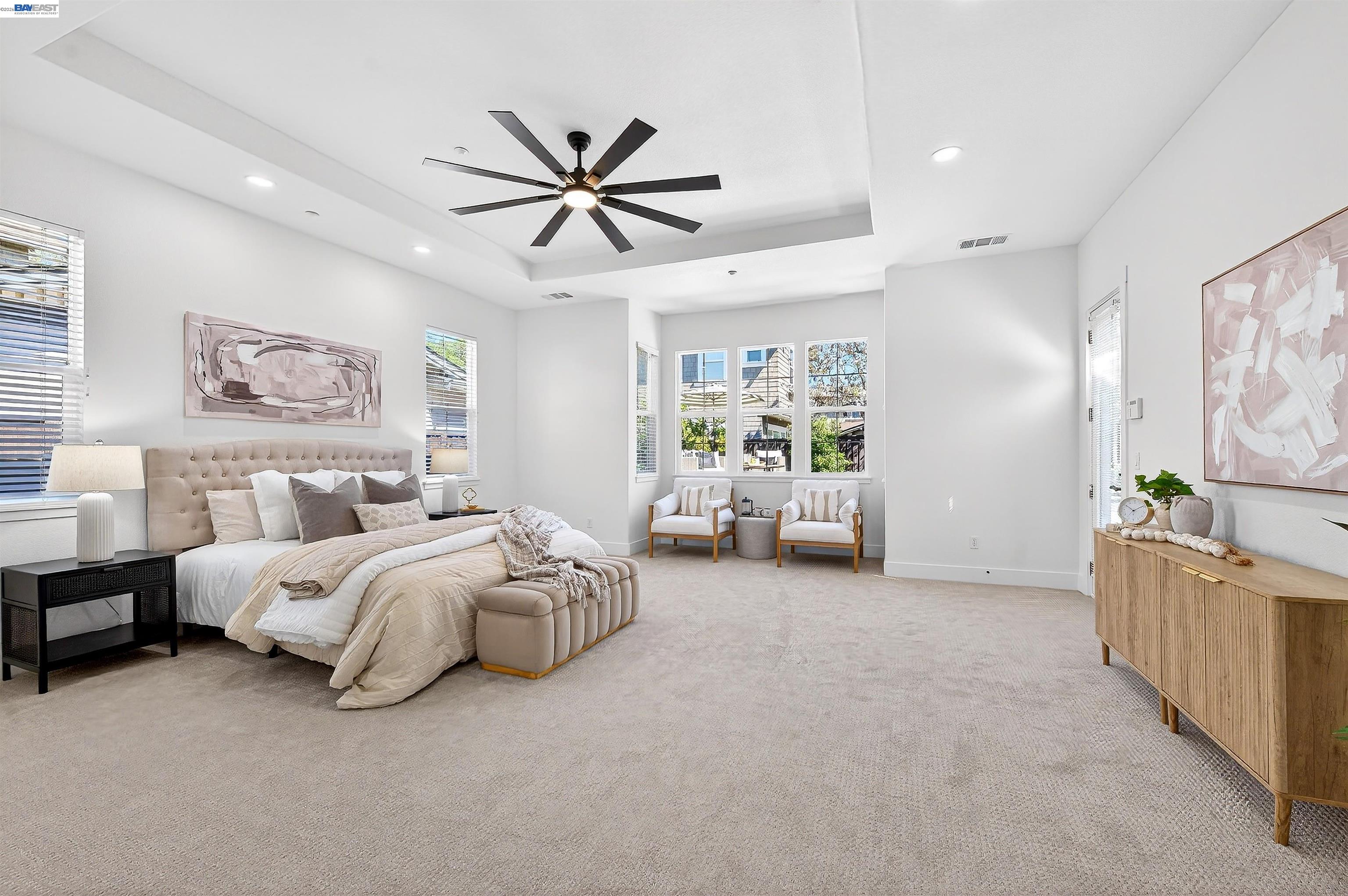 5564 Stockton Loop Livermore, CA 94550 - Photo 17 of 45 a spacious bedroom with a bed and a chandelier