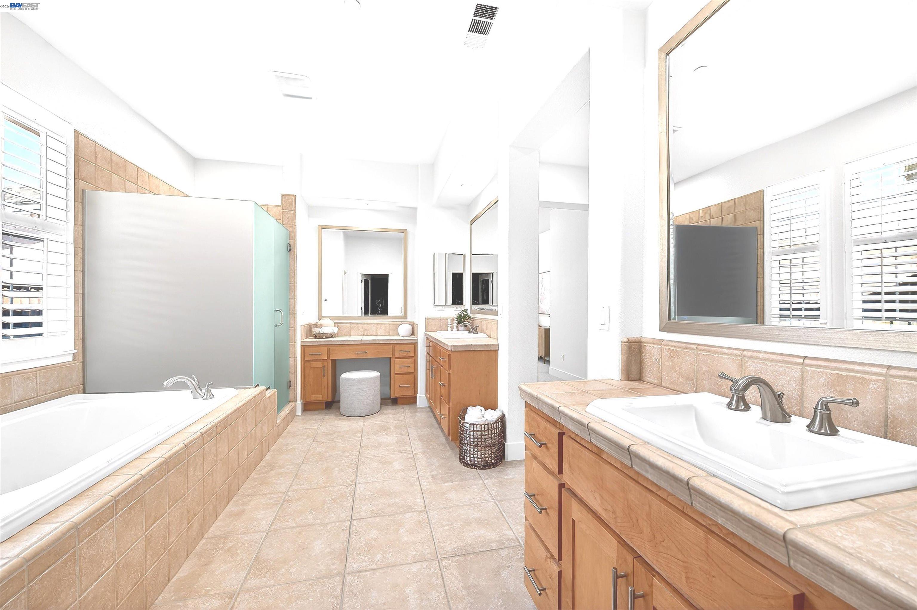 5564 Stockton Loop Livermore, CA 94550 - Photo 19 of 45 a spacious bathroom with a sink and mirror