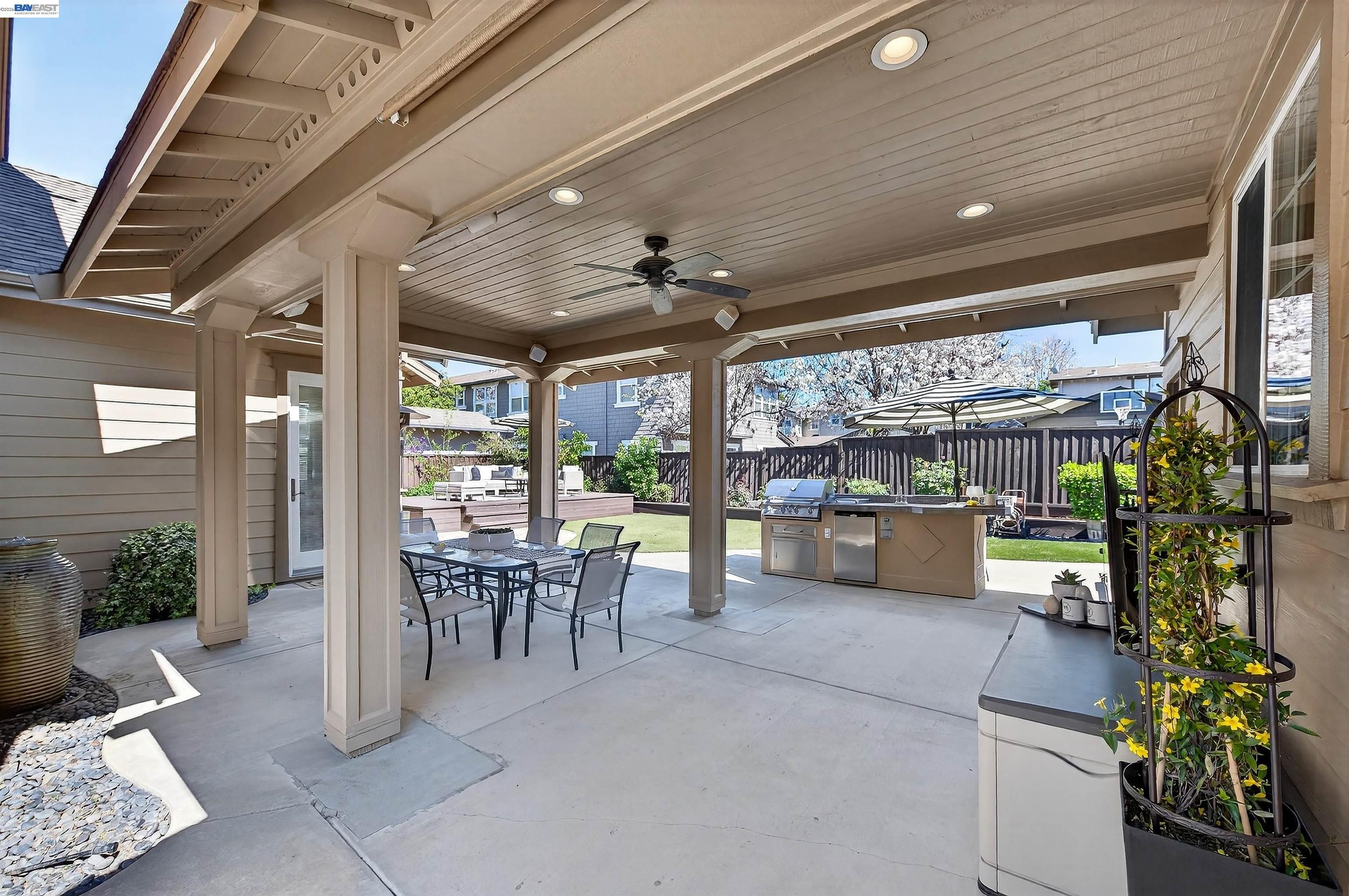 5564 Stockton Loop Livermore, CA 94550 - Photo 25 of 45 a view of a patio with table and chairs potted plants