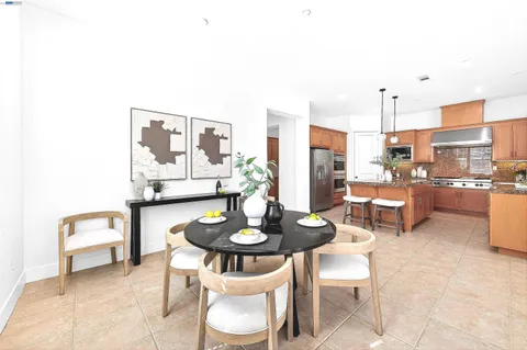 a dining room with furniture and a kitchen view