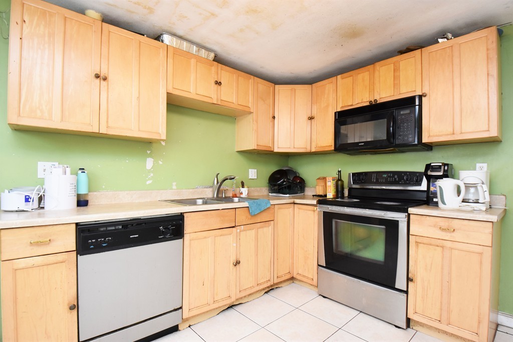 a kitchen with stainless steel appliances granite countertop a sink and cabinets
