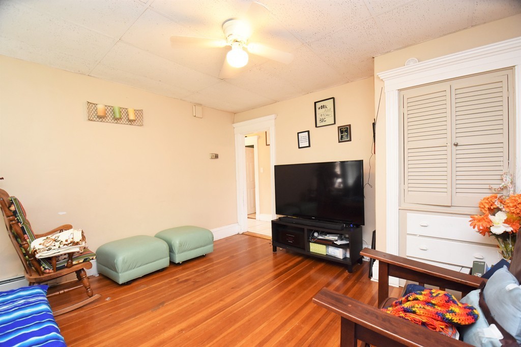 84 Vernal Street Everett, MA 02149 - Photo 12 of 26 a living room with furniture and a flat screen tv