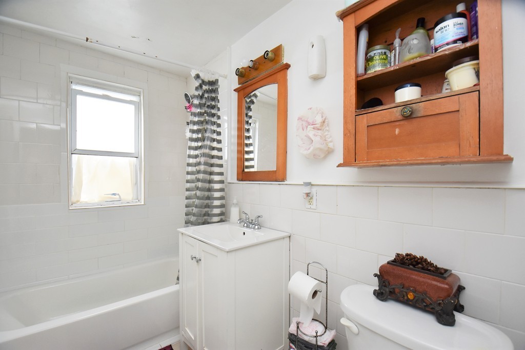 84 Vernal Street Everett, MA 02149 - Photo 15 of 26 a bathroom with a sink toilet and vanity