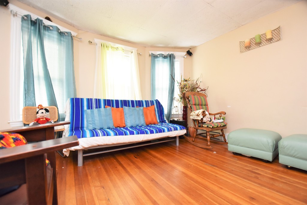 84 Vernal Street Everett, MA 02149 - Photo 6 of 26 a living room with furniture and a wooden floor
