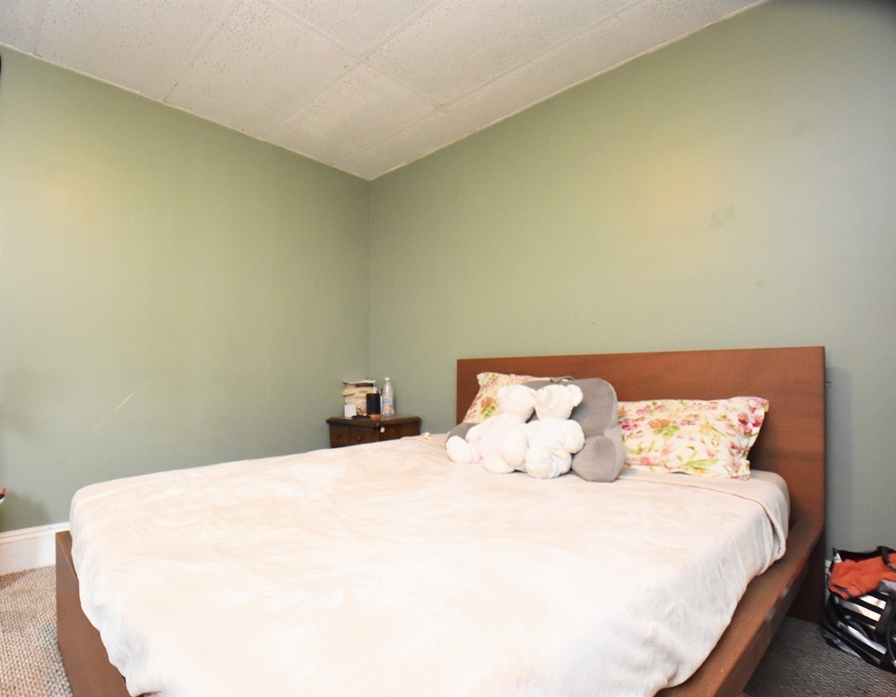 84 Vernal Street Everett, MA 02149 - Photo 9 of 26 a bedroom with a bed and pillows