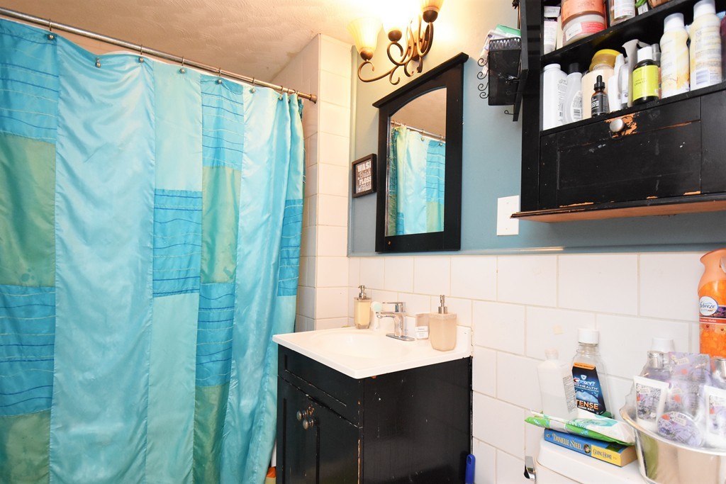 84 Vernal Street Everett, MA 02149 - Photo 10 of 26 a bathroom with a sink and a mirror