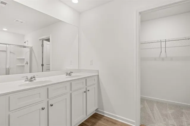 a bathroom with a double vanity sink and mirror