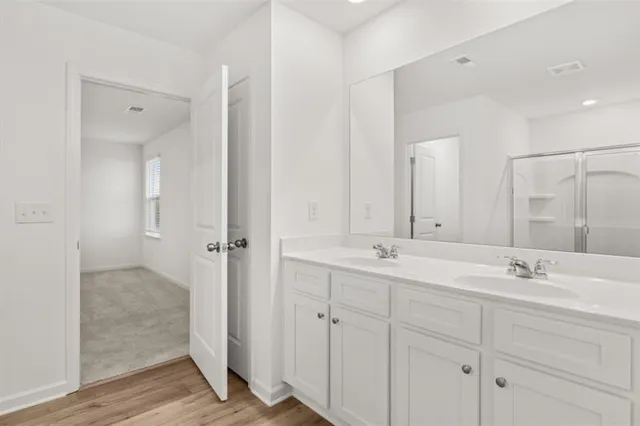 a bathroom with a double vanity sink mirror and