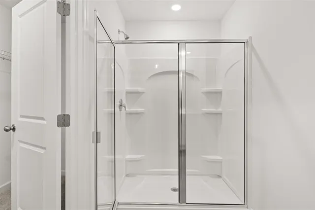 a bathroom with a glass shower door
