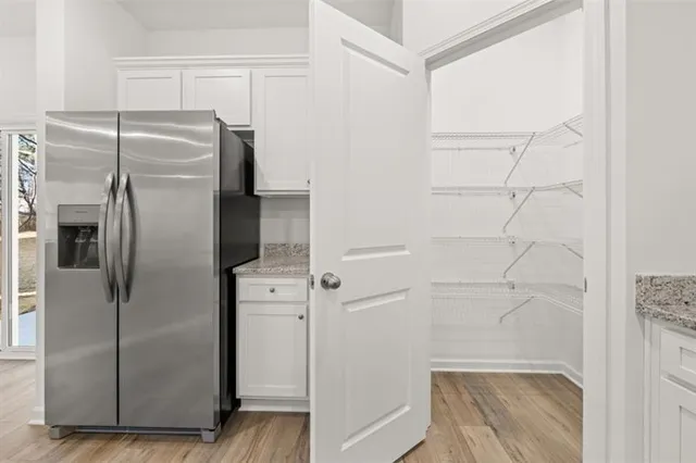 a metallic refrigerator freezer sitting in a kitchen